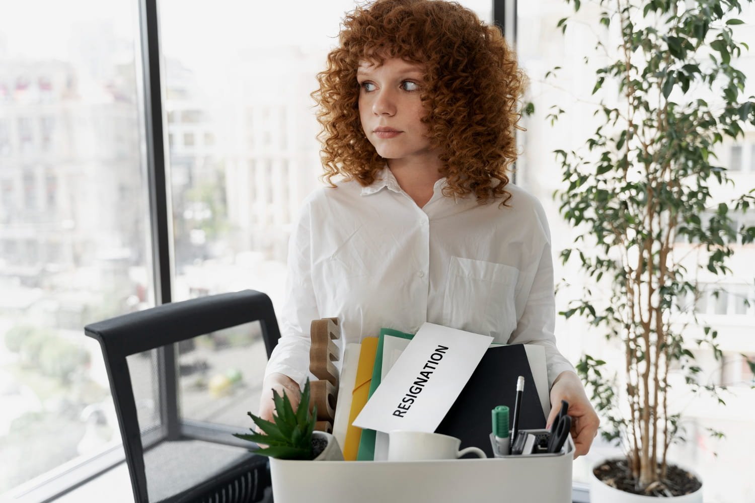 Professional in their 30s looking at career options on laptop with confident expression